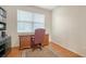 Office space with a wood desk, area rug, and natural light from a window at 5044 Creekside Trl, Sarasota, FL 34243
