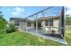 Screened patio with landscaped yard and outdoor seating area at 5044 Creekside Trl, Sarasota, FL 34243