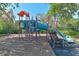 Community playground with climbing structures, slides and shade trees at 5044 Creekside Trl, Sarasota, FL 34243
