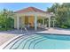 Community pool with covered seating area and tiled deck at 5044 Creekside Trl, Sarasota, FL 34243