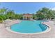 Community pool area features a pool, cabana, lounge chairs, tables, and lush landscaping at 5044 Creekside Trl, Sarasota, FL 34243