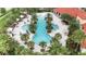 Aerial view of a resort style pool featuring palm trees, lounge chairs, and umbrellas at 5213 Patano Loop, Palmetto, FL 34221