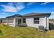Rear view of the home featuring a covered patio, backyard, and neutral siding at 5213 Patano Loop, Palmetto, FL 34221