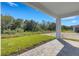 Backyard features a covered patio, brick pavers, and lush green lawn at 5213 Patano Loop, Palmetto, FL 34221