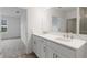Bright bathroom features a double sink vanity and doorway to the bedroom at 5213 Patano Loop, Palmetto, FL 34221