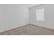 Empty bedroom with neutral carpet and window at 5213 Patano Loop, Palmetto, FL 34221