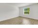 Bright bedroom features wood-style tile flooring and a window with outdoor views at 5213 Patano Loop, Palmetto, FL 34221
