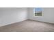Cozy bedroom with neutral carpet, a window and light walls at 5213 Patano Loop, Palmetto, FL 34221