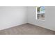 Bright bedroom features a window allowing natural light and neutral carpet at 5213 Patano Loop, Palmetto, FL 34221
