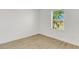 Bedroom featuring a hardwood floor, white walls, and a window with an exterior view at 5213 Patano Loop, Palmetto, FL 34221
