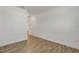 An empty bedroom featuring a hardwood floor, white walls, and a view into the hallway at 5213 Patano Loop, Palmetto, FL 34221