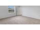 Bright bedroom with plush carpeting, a window and neutral wall color at 5213 Patano Loop, Palmetto, FL 34221