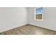 An empty bedroom featuring a hardwood floor, white walls, and a single window at 5213 Patano Loop, Palmetto, FL 34221