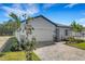 Beautiful one-story home featuring a well-manicured lawn, brick driveway, and attached two-car garage at 5213 Patano Loop, Palmetto, FL 34221