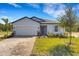 Charming single-story home with a well-maintained lawn, brick driveway, and a two-car garage at 5213 Patano Loop, Palmetto, FL 34221