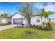 Inviting home with mature palm trees, well-maintained lawn, and move-in ready availability at 5213 Patano Loop, Palmetto, FL 34221