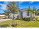 Charming home with well-manicured landscaping, a paver driveway, and a two-car garage at 5213 Patano Loop, Palmetto, FL 34221