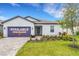 Charming single-story home featuring manicured landscaping and a welcoming front entrance, ready for quick move-in at 5213 Patano Loop, Palmetto, FL 34221