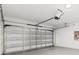 Spacious garage with an automatic door, offering ample room for vehicles and storage on a speckled floor at 5213 Patano Loop, Palmetto, FL 34221