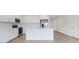 Stylish kitchen featuring white cabinets, stainless steel appliances, and a center island with sleek countertops at 5213 Patano Loop, Palmetto, FL 34221
