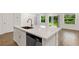 Bright kitchen island with white cabinets, stainless steel appliances, and views of the backyard at 5213 Patano Loop, Palmetto, FL 34221