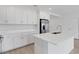Modern kitchen showcasing white cabinetry, marble countertops, and stainless steel appliances at 5213 Patano Loop, Palmetto, FL 34221