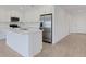 Well-appointed kitchen with white cabinetry, stainless steel refrigerator, and a central island with marble countertop at 5213 Patano Loop, Palmetto, FL 34221