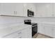 Bright kitchen with white cabinets, stainless steel appliances, and quartz countertops at 5213 Patano Loop, Palmetto, FL 34221