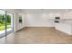 Open kitchen with stainless appliances, tile floors, backyard patio access, and abundant natural light at 5213 Patano Loop, Palmetto, FL 34221