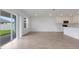 Spacious living area with sliding glass doors providing access to the outdoor space, complemented by a modern kitchen at 5213 Patano Loop, Palmetto, FL 34221