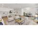 Open-concept living space with modern furnishings, including a dining area and white kitchen at 5213 Patano Loop, Palmetto, FL 34221
