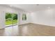 Open concept living room with light tile floors, sliding glass doors to backyard and window at 5213 Patano Loop, Palmetto, FL 34221