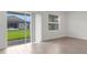 Bright and airy living room featuring sliding glass doors leading to a patio with a private backyard view at 5213 Patano Loop, Palmetto, FL 34221