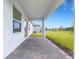 Covered brick paver patio, ideal for relaxing and enjoying the beautiful backyard view at 5213 Patano Loop, Palmetto, FL 34221