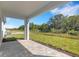 Covered patio offers a relaxing outdoor space with views of the backyard and nature at 5213 Patano Loop, Palmetto, FL 34221