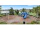 Community playground with blue slides and climbing structures, set in a grassy area near a lake at 5213 Patano Loop, Palmetto, FL 34221