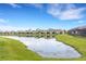 Scenic view of community pond and fountain with lush grassy banks surrounded by attractive houses at 5213 Patano Loop, Palmetto, FL 34221