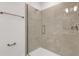Close-up of modern shower with tile surround, glass door, and bronze fixtures at 5213 Patano Loop, Palmetto, FL 34221