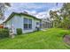 Beautiful backyard featuring lush green lawn, screened-in pool and patio, creating an outdoor oasis at 5285 Far Oak Cir, Sarasota, FL 34238