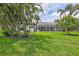 A beautiful backyard and lawn with an in-ground pool and lanai area at 5285 Far Oak Cir, Sarasota, FL 34238