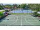 Recreational courts for tennis and basketball surrounded by mature trees, enhancing community fitness options at 5285 Far Oak Cir, Sarasota, FL 34238