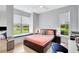Comfortable bedroom features a window seat overlooking the water and two large windows at 5285 Far Oak Cir, Sarasota, FL 34238