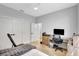 Bright bedroom with wood floors features a desk, closet, and modern ceiling fan at 5285 Far Oak Cir, Sarasota, FL 34238