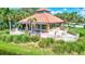 Community clubhouse showcasing a tranquil waterfront location, complemented by lush landscaping at 5285 Far Oak Cir, Sarasota, FL 34238