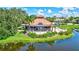 Community clubhouse with beautiful landscaping, outdoor seating, perfect for relaxation and social gatherings at 5285 Far Oak Cir, Sarasota, FL 34238