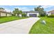Inviting single-story home with a long driveway and lush landscaping at 5285 Far Oak Cir, Sarasota, FL 34238