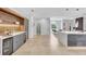 Well-designed kitchen with a sleek island, built-in shelving, and beverage cooler at 5285 Far Oak Cir, Sarasota, FL 34238