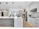 Well-lit kitchen with an island, stainless steel refrigerator, and open floor plan at 5285 Far Oak Cir, Sarasota, FL 34238