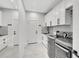 Clean laundry room with white cabinets and modern washer and dryer units at 5285 Far Oak Cir, Sarasota, FL 34238