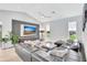Inviting living room features a large leather sofa, vaulted ceilings, and modern decor at 5285 Far Oak Cir, Sarasota, FL 34238